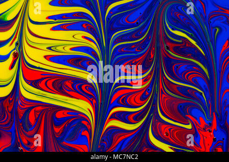 Abstract liquid paint swirl background design in blue, yellow and red watercolor paint Stock Photo