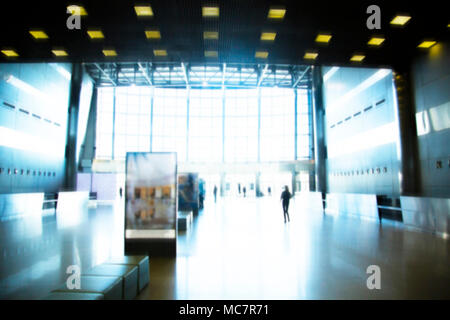abstract blurred background : crowd people at terminal department at airport with bokeh light. Stock Photo
