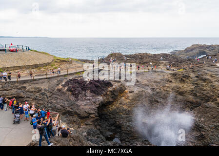 Kiama, NSW, Australia-March 31, 2018: Tourists visiting Kiama Blowhole, one of the largest blowholes in the world, a sea-cliff cavern that spouts seaw Stock Photo