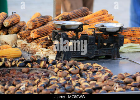 An old Kuleli weight scale, grilled corncobs and roasted chestnuts on a market in Istanbul, Turkey Stock Photo