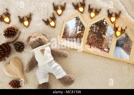 Houses shape wooden photo frames over cozy and warm fur carpet. Scandinavian style design. Top view Stock Photo