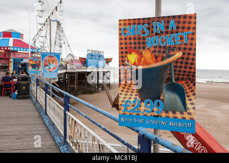 poster advertising chips in a bucket on the central pier in Blackpool. Stock Photo