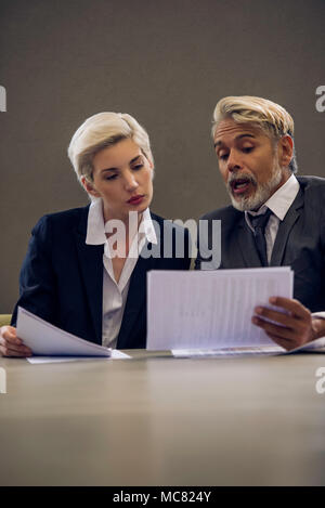 Woman and man reviewing document together Stock Photo