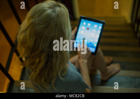 Woman using digital tablet at home Stock Photo