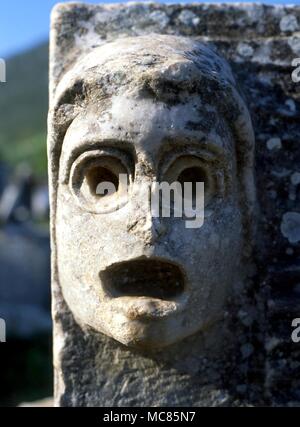 GREEK MYTHOLOGY Actor's mask in front of the theatre at Epheseus, Turkey. The theatre was originally built by the Greeks and restored by the Romans Stock Photo