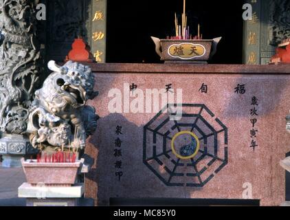 I Ching The Tai Chi, with the pa qua right (or eight trigrams of the I Ching), on an altar in a Taoist Chinese Temple in Penang, Malaysia Stock Photo
