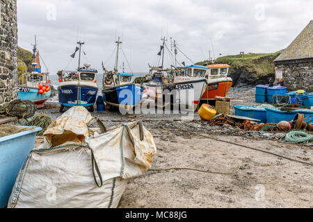 Cadgwith Cove.  Inshore Fishing boats hauled ashore to protect them from bad weather Stock Photo