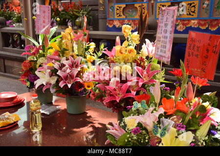 Flowers on a table inside Longshan buddhist temple in Taipei, Taiwan Stock Photo