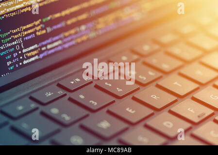 Closeup programmer coding on screen. Hands coding html and programming on laptop screen, web development, developer Closeup coding, programming on lap Stock Photo