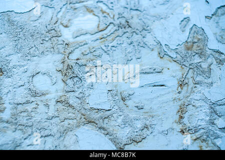 Grey grunge dilapidated wooden surface with small pieces of peel-off paint and putty on it. Stock Photo
