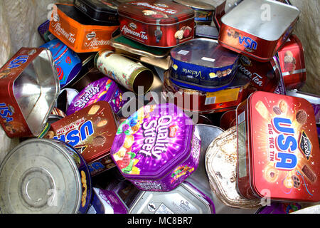 empty biscuit tins collected and bagged up ready to be recycled in a metal recycling plant. Stock Photo