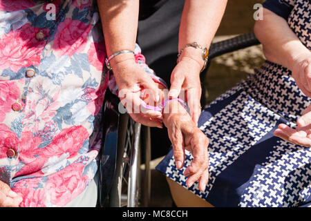 old womans is having wearable device smart watch in care home retirement house. Stock Photo