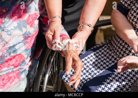 old womans is having wearable device smart watch in care home retirement house. Stock Photo