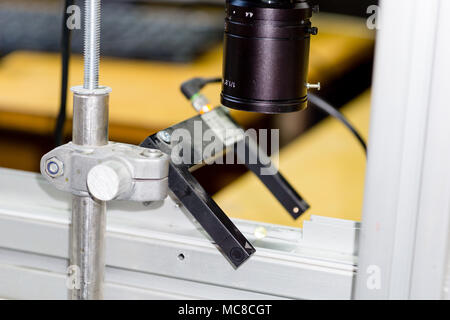 Robotic machine vision system in factory. industry 4.0. Camera lens and optical sensor on conveyor installed Stock Photo