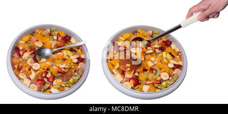 Healthy fruit salad in two big bowls. Juicy colorful mix of chopped fruits in plastic basins, spoon, hand holding ladle. Isolated on white background. Stock Photo