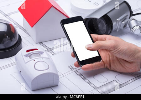 Architect's Hand Using Mobile Phone With Blank White Screen Stock Photo