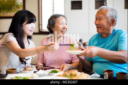 daughter and senior parent enjoy dinner in restaurant Stock Photo