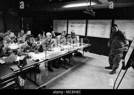 U.S. Army Staff Sgt. Change L. McGraw, a Paratrooper assigned to the 173rd Airborne Brigade instructs Italian Army Paratroopers assigned to Regiment “Savoia Cavalleria” Folgore Brigade Grosseto, during training using Call For Fire Trainer system (CFFT) at Caserma Ederle Vicenza, Italy, March 27, 2018. Italian Paratroopers use U.S. Army RTSD South equipment to enhance bilateral relations and to expand levels of cooperation and the capacity of the personnel involved in joint operations. Stock Photo