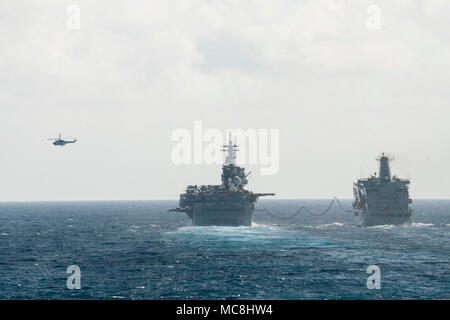 PHILIPPINE SEA (March 29, 2018) The amphibious assault ship USS Wasp (LHD 1) and the fleet replenishment oiler USNS Tippecanoe (T-AO 199) conduct a connected replenishment. Wasp is operating in the Indo-Pacific region as part of a regularly scheduled patrol and provides a rapid-response capability in the event of a regional contingency or natural disaster. Stock Photo