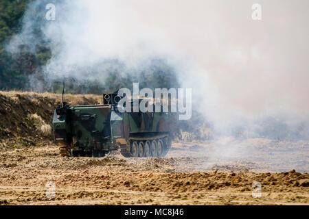 A M58 Wolf is remotely controlled to release a cloud of smoke during a multinational joint equipment U.S. military training exercise at Grafenwoehr Training Area, Germany, April 2, 2018 in preparation for a Robotic Complex Breach Concept demonstration. The Robotic Complex Breach Concept includes the employment of Robotic and Autonomous Systems (RAS) in intelligence, suppression, obscuration, and reduction. Stock Photo