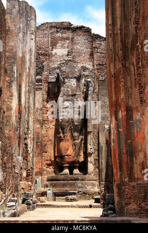 A giant masoned Standing Buddha statue without head in a temple in the royal ancient city of Polonnaruwa in Sri Lanka Stock Photo