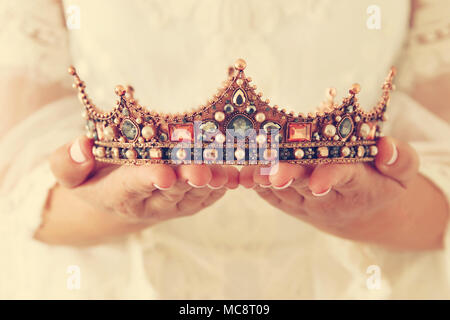 image of beautiful lady with white lace dress holding diamond crown. fantasy medieval period Stock Photo