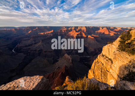 Sunset lights the rim of the Grand Canyon in orange and gold Stock Photo