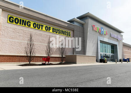 A logo sign outside of a joint Toys 'R' Us and Babies 'R' Us retail store in Columbia, Maryland with 'Going Out Of Business' signage on April 13, 2018 Stock Photo