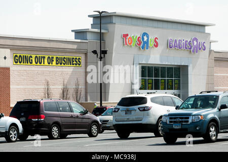 A logo sign outside of a joint Toys 'R' Us and Babies 'R' Us retail store in Columbia, Maryland with 'Going Out Of Business' signage on April 13, 2018 Stock Photo