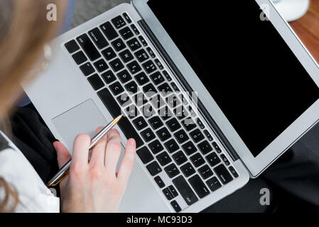 top view of laptop and female hands while working Stock Photo