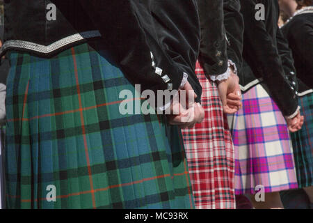 Girls wearing irish skirts background green red pattern squares Stock Photo