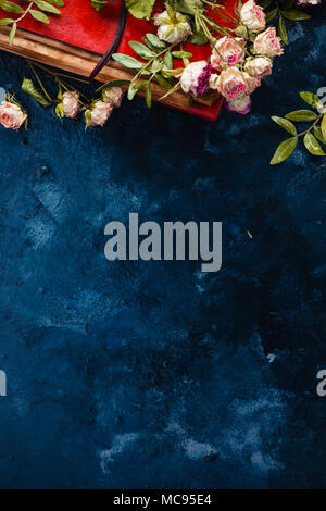 Vintage book with dried roses on a dark background. Romantic concept with copy space. Stock Photo