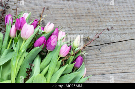 beautiful bouquet of pink and violet tulips on a wooden background Stock Photo