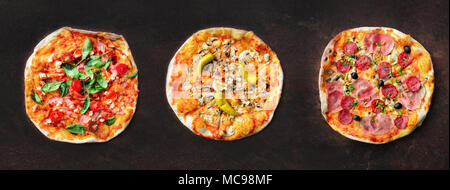 Pizza pattern. Three pieces set on dark background. Top view, copyspace Stock Photo