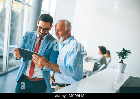 Portrait of businessmen with digital tablet in office Stock Photo