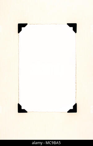 Blank old photo for your picture, with photo corners on aged paper. Stock Photo