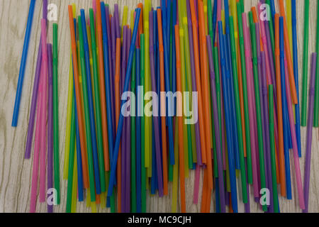 Colored plastic drinking straws on a white background Stock Photo