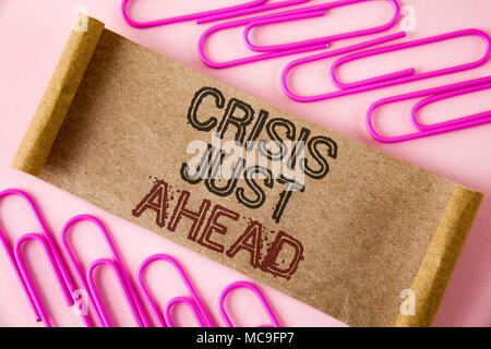 Handwriting text writing Crisis Just Ahead. Concept meaning Foresee failure take right action before it is late written Folded Cardboard paper piece p Stock Photo
