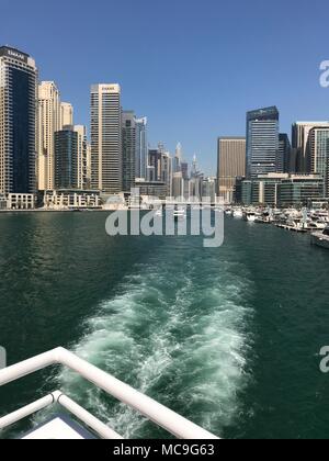 A track from a yacht on the water departing from the city.