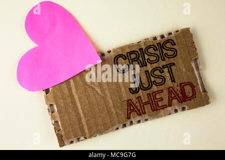Handwriting text Crisis Just Ahead. Concept meaning Foresee failure take right action before it is late written Tear Cardboard Piece on the plain back Stock Photo