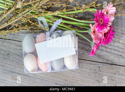 Easter eggs with pink gerbera and white copy space Stock Photo