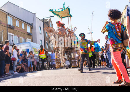 Hackney, London, UK. 11th September 2016. People watching the parade with a big elephant float approaching during the Hackney Carnival 2016 in Ridley  Stock Photo