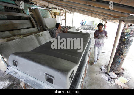 Bogor, Indonesia. 14th Apr, 2018. Workers on a fiber glass make truck and bus accessories in studio at Bogor, West Java, Indonesia. Product of bus and truck car such as front cowl bus, rear cowl bus, Dashboard bus, Front ducting bus, rear ducting bus, roof bus, and cover corner sold to bus companies and trucks to Asia. Credit: Adriana Adinandra/Pacific Press/Alamy Live News Stock Photo