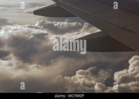 View of two pylons and rear view of aircraft wings over cloud cover ...