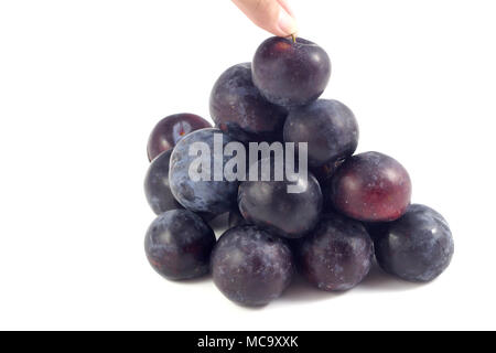 Sweet plum, prunes isolated on white background, Group of plums, prunes with leaf isolated on a white background. Fresh of plum, prunes fruit that hel Stock Photo