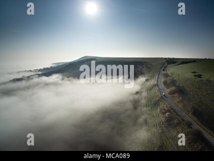 Firle, East Sussex. 14th April 2018. The South Downs emerge from low lying morning mist covering the Low Weald on a bright spring morning. © CAP/Alamy Live News Stock Photo