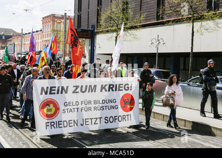 Mannheim, Germany. 14th April 2018. Protesters carry a banner that reads 'No to war - Money for education instead of weapons - Pace now immediately'. Kurdish people and German supporters marched through Mannheim to protest against the continued occupation of the Syrian city of Afrin, which was controlled by the Kurdish Popular Protection Units (YPG) before it got conquered by the Turkish army. They also protested against the German involvement via weapons exports to Turkey. Credit: Michael Debets/Alamy Live News Stock Photo