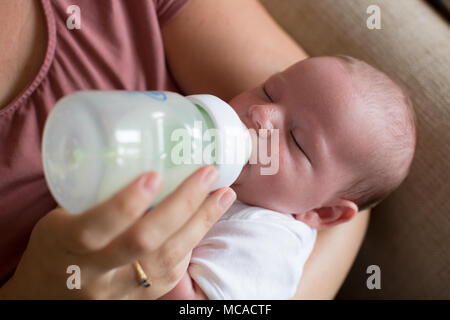 Young baby being bottle fed. Stock Photo