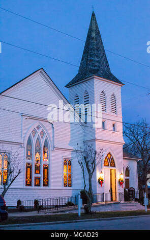 Church at dusk in historic Beaufort, NC - stained glass windows catch the evening light. Serene, peaceful, inspirational Stock Photo