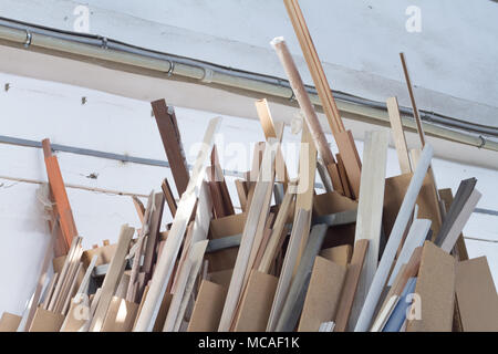 Furniture accessories. Colorful wooden floor for home renovation. Manufacture of skirting boards in a furniture factory. Stock Photo